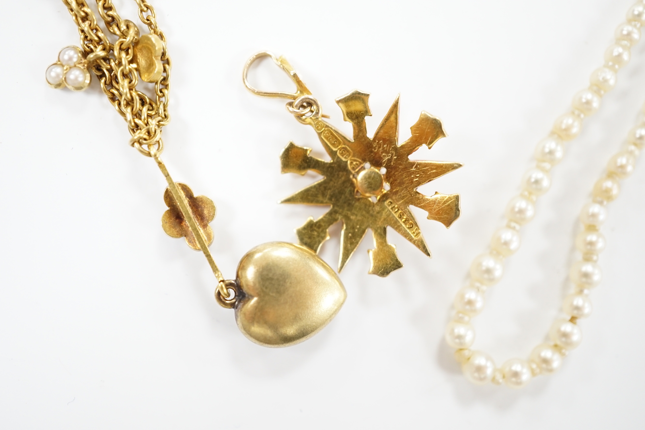 An Edwardian 15ct gold and seed pearl set starburst pendant, overall 25mm, together with a similar yellow metal and seed pearl set heart shaped drop pendant necklace, approx. 38cm (twisted) and a seed pearl necklace with